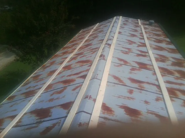 Rusted metal roof panels with new wood purlins before replacement — Storm Damage Roof Repair in Poestenkill by Roofing Brothers